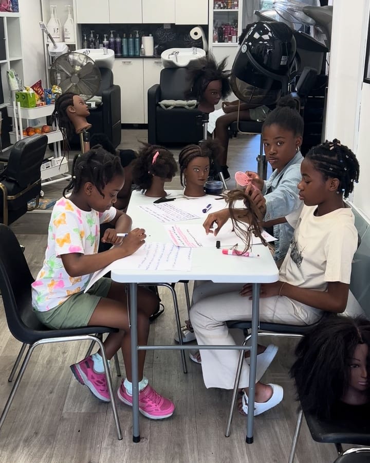 Children practising hair care techniques during a Salon ABV Summer Hair School session